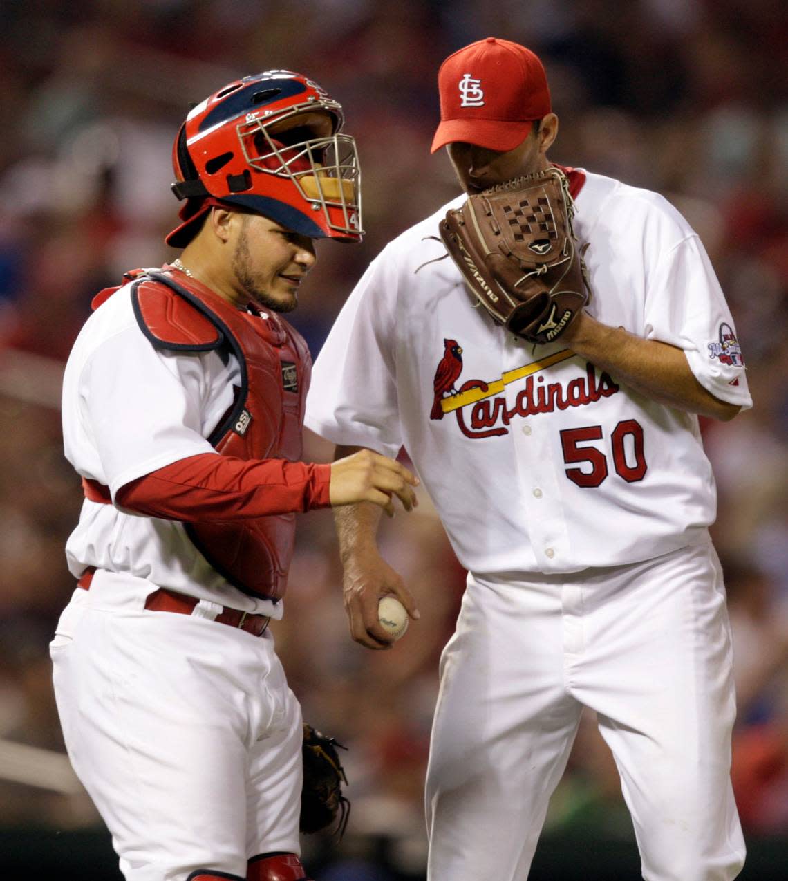 St. Louis Cardinals catcher Yadier Molina, left, and starting pitcher Adam Wainwright talk on the mound during the fifth inning of a baseball game against the Chicago Cubs, Friday, April 24, 2009, in St. Louis. (AP Photo/Jeff Roberson)