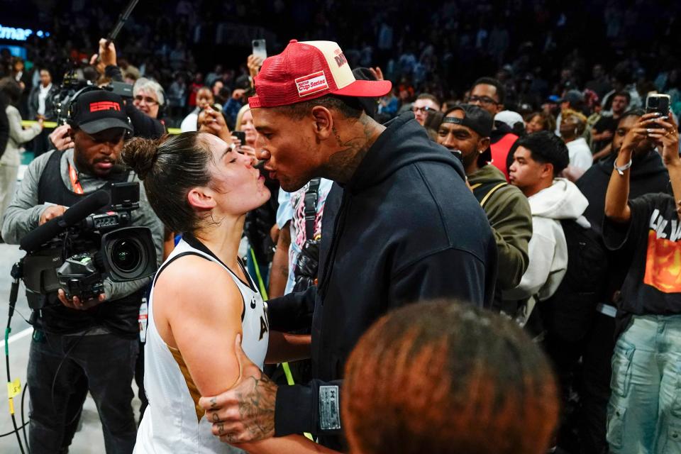 Las Vegas Aces' Kelsey Plum, left, kisses New York Giants' Darren Waller after Game 4 of a WNBA basketball final playoff series against the New York Liberty Wednesday, Oct. 18, 2023, in New York. The Aces won 70-69. (AP Photo/Frank Franklin II)