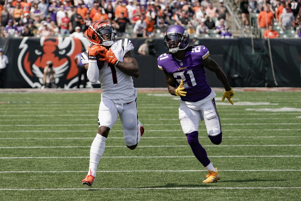 Cincinnati Bengals wide receiver Ja'Marr Chase (1) makes a catch and takes it in for a touchdown past Minnesota Vikings defensive back Bashaud Breeland (21) in the first half of an NFL football game, Sunday, Sept. 12, 2021, in Cincinnati. (AP Photo/Jeff Dean)