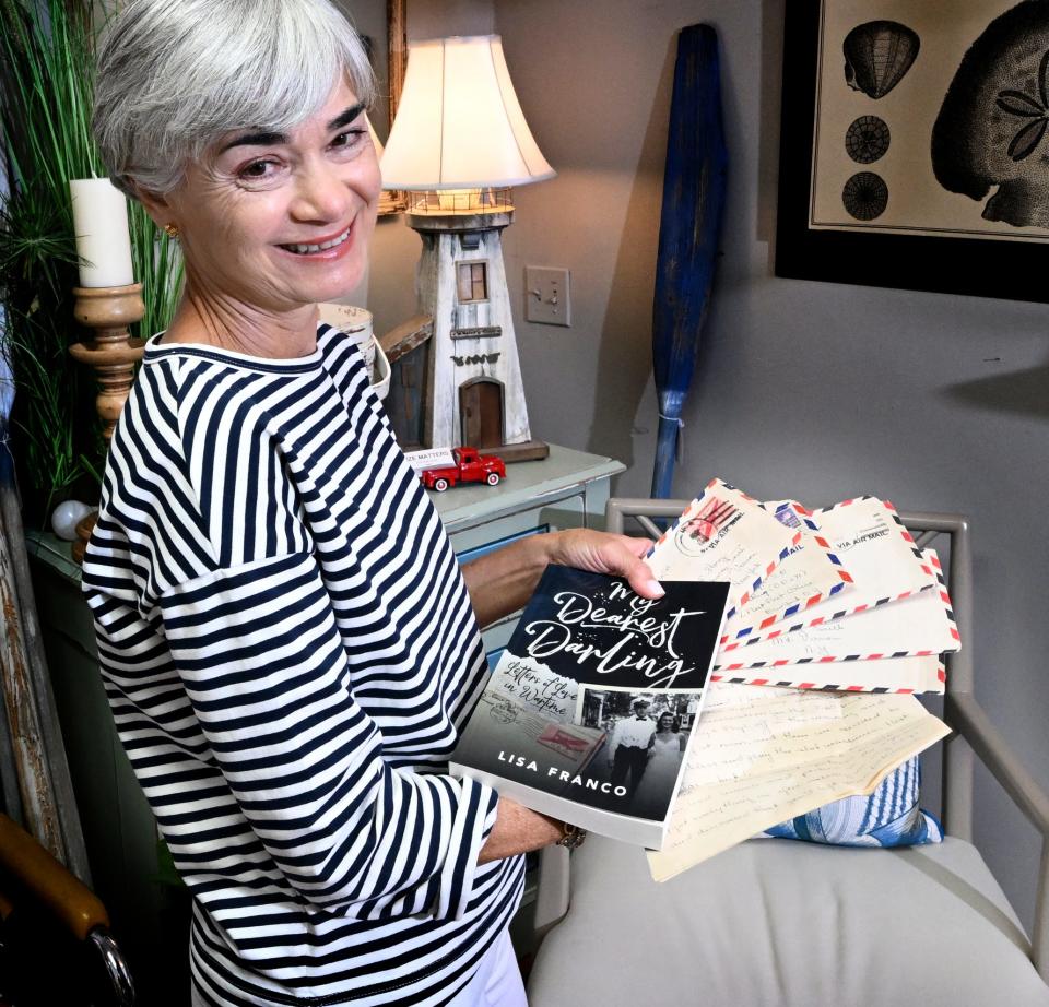 Author Lisa Franco with some of the 150 WWII love letters she found in a Cape antiques store and the novel she wrote about the couple's romance. Franco has since returned the letters to the family.