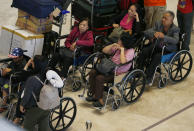 Airline passengers gather to check their flights at the Ninoy Aquino International Airport after a Chinese Xiamen Air Boeing passenger plane skidded off the runway while landing Friday, Aug. 17, 2018, in Manila, Philippines. The Xiamen Air flight MF8667 has skidded off a runway at Manila's airport while landing in a downpour and its 157 passengers and eight crew members have been evacuated by emergency slide. (AP Photo/Bullit Marquez)