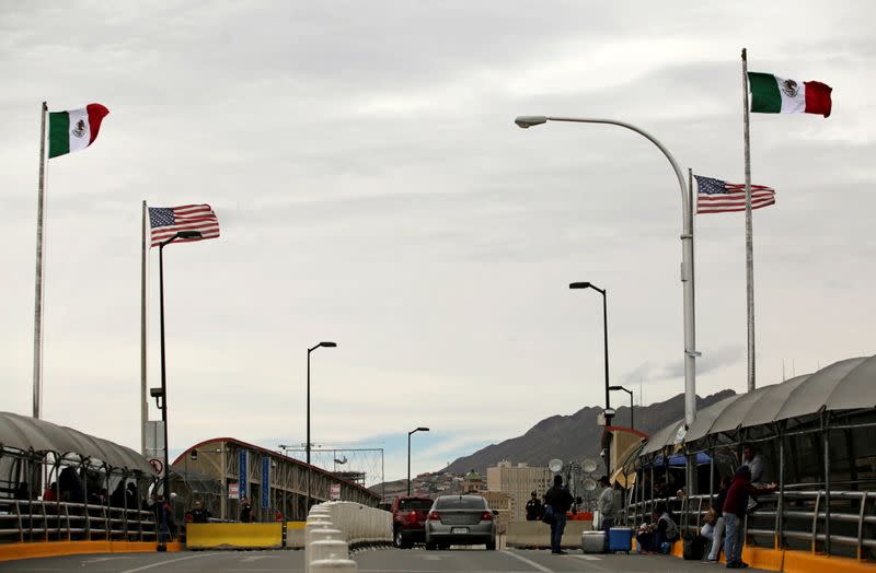 FILE PHOTO: People queue to cross into the U.S. at the Paso del Norte border crossing bridge, as seen from Ciudad Juarez