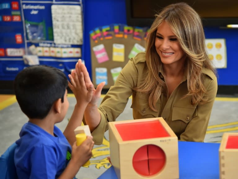 First Lady Melania Trump shares a laugh with a child during a visit to the American International School in the Saudi capital Riyadh on May 21, 2017