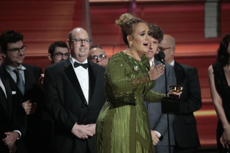 A woman onstage in a green gown