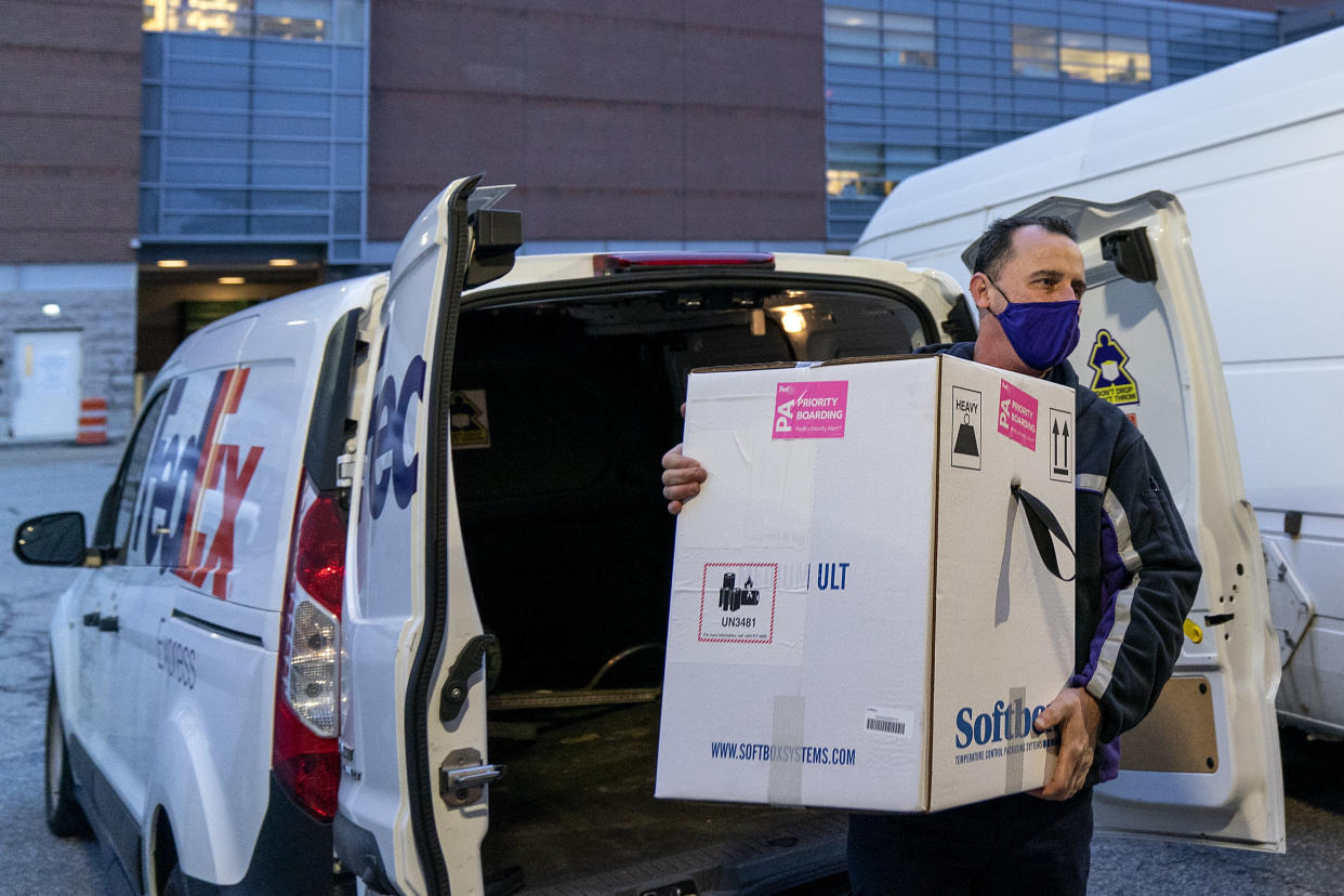 A FedEx driver delivers a box containing the Pfizer-BioNTech COVID-19 vaccine to Rhode Island Hospital in Providence, R.I, Monday, Dec. 14, 2020. (AP Photo/David Goldman)