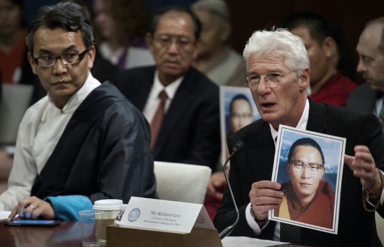 US actor Richard Gere (R) holds a photo of Tibetan monk Tenzin Delek Rinpoche, who died in a Chinese prison, before the Tom Lantos Human Rights Commission hearing, July 14, 2015 on Capitol Hill in Washington, DC