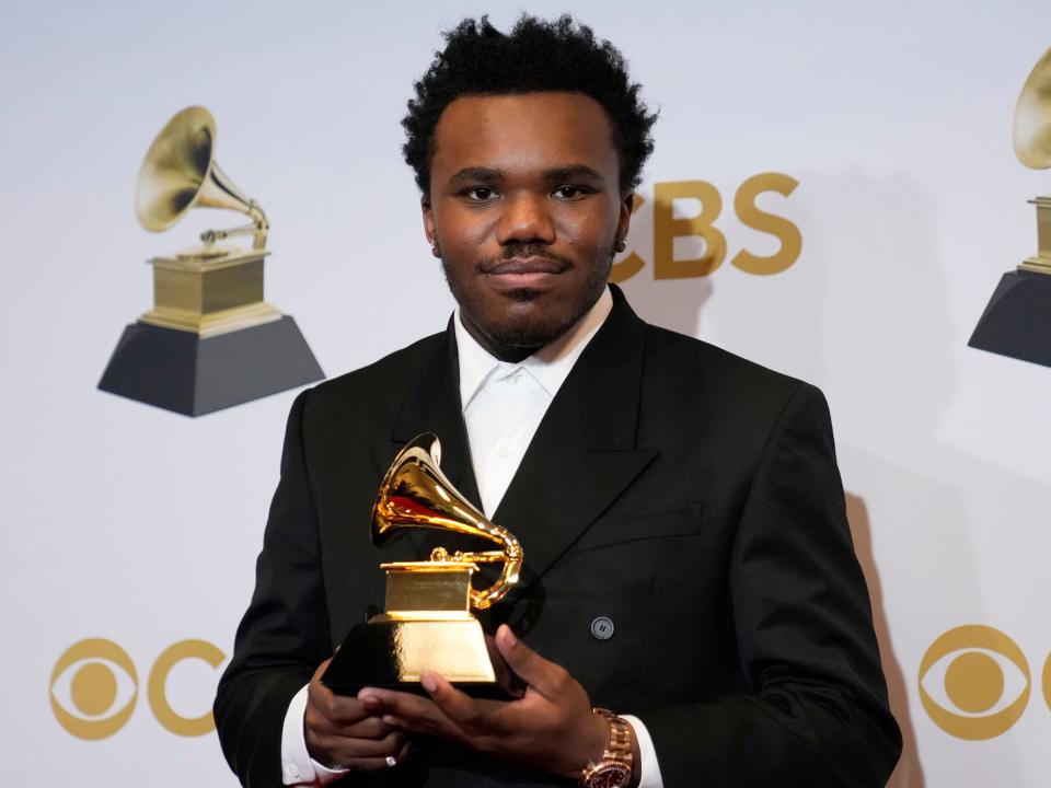 Baby Keem posing with his award at the 2022 Grammys.