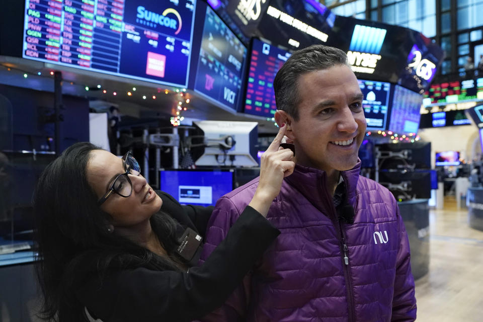 Nubank Founder and CEO David Velez is fitted for an interview earphone by Judy Shaw on the New York Stock Exchange floor before his company's IPO, Thursday, Dec. 9, 2021. (AP Photo/Richard Drew)