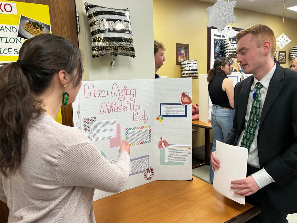 Dylan Brothers, academic coordinator for HCA's Portsmouth Regional Hospital, Frisbie Memorial Hospital and Parkland Medical Center, works with a student in one of three programs offered to students exploring careers in health care.