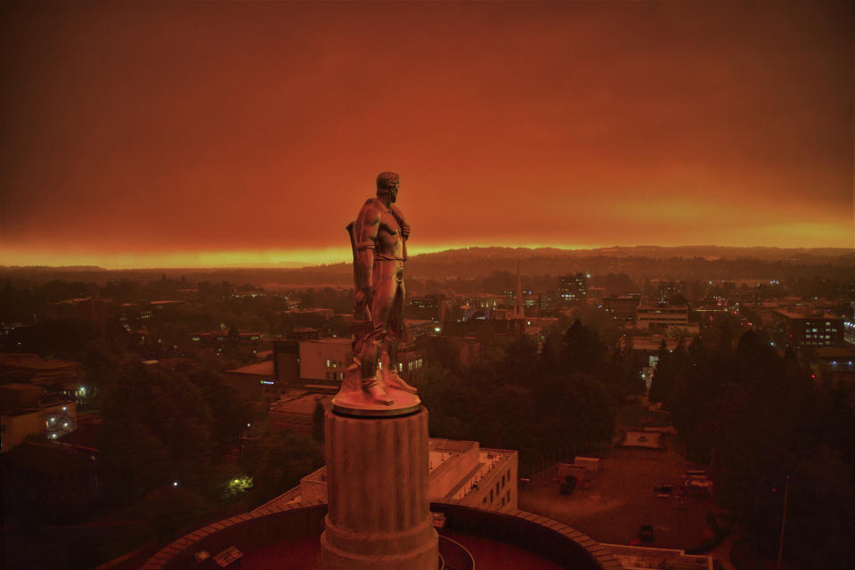 This drone photo provided by Michael Mann shows the Oregon Capitol building, with its "Oregon Pioneer" bronze sculpture atop the dome, with skies filled with smoke and ash from wildfires as a backdrop in Salem, Ore., on Sept. 8, 2020. Fires continued to rage across the West Coast on Monday, Sept. 21, 2020. (Michael Mann via AP)