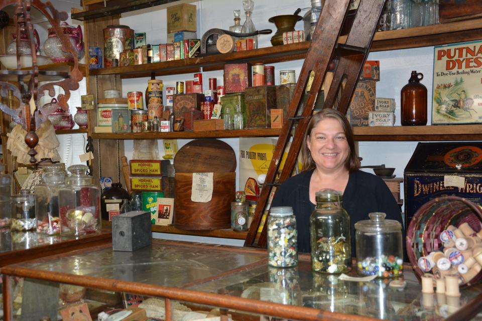 Beth Holler Page shows the country store display in the Springs Museum.