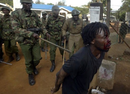 File photo shows a Kenyan demonstrator wounded after being beataen by anti-riot police in December 2007 at Kibera slum in Nairobi. The International Criminal Court has confirmed charges against four out of six Kenyan officials, who will now face trial over deadly post-election unrest four years ago in which 1,100 died