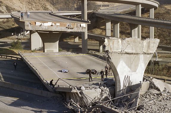 Following the 1994 Northridge quake, the covered body of Los Angeles Police Officer Clarence Wayne Dean, 46, lies on a collapsed highway.