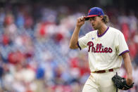 Philadelphia Phillies' Aaron Nola tips his cap to the fans as he heads off the field during the ninth inning of a baseball game against the Atlanta Braves, Sunday, July 25, 2021, in Philadelphia. (AP Photo/Chris Szagola)
