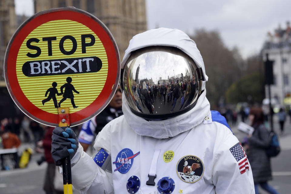 A demonstrator in an astronaut suit carries a sign during a Peoples Vote anti-Brexit march in London, Saturday, March 23, 2019. The march, organized by the People's Vote campaign is calling for a final vote on any proposed Brexit deal. This week the EU has granted Britain's Prime Minister Theresa May a delay to the Brexit process. (AP Photo/Kirsty Wigglesworth)