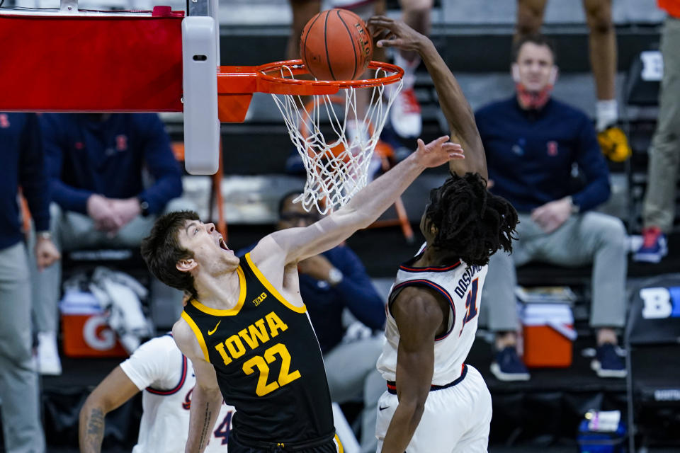 Illinois guard Ayo Dosunmu (11) gets a dunk over Iowa forward Patrick McCaffery (22) in the second half of an NCAA college basketball game at the Big Ten Conference tournament in Indianapolis, Saturday, March 13, 2021. (AP Photo/Michael Conroy)