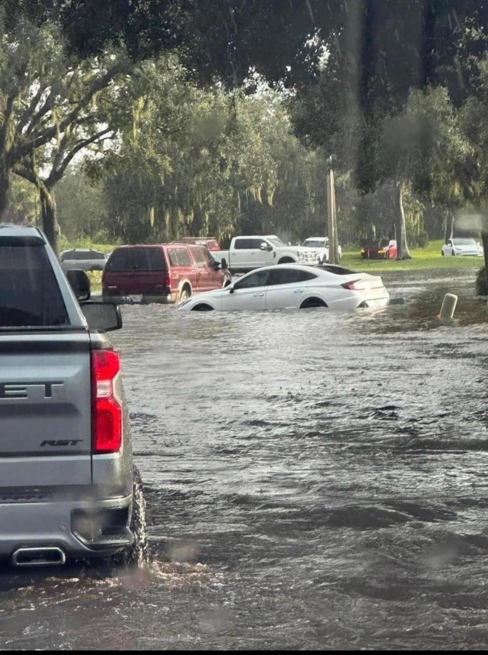 Dozens of vehicles were abandoned on Imperial Lakes Boulevard Thursday afternoon as a section of the road was flooded by over 2 feet of water by a rainstorm. The flooded roadway left the massive 1,700-acre golf course community inaccessible to its nearly 10,000 residents.