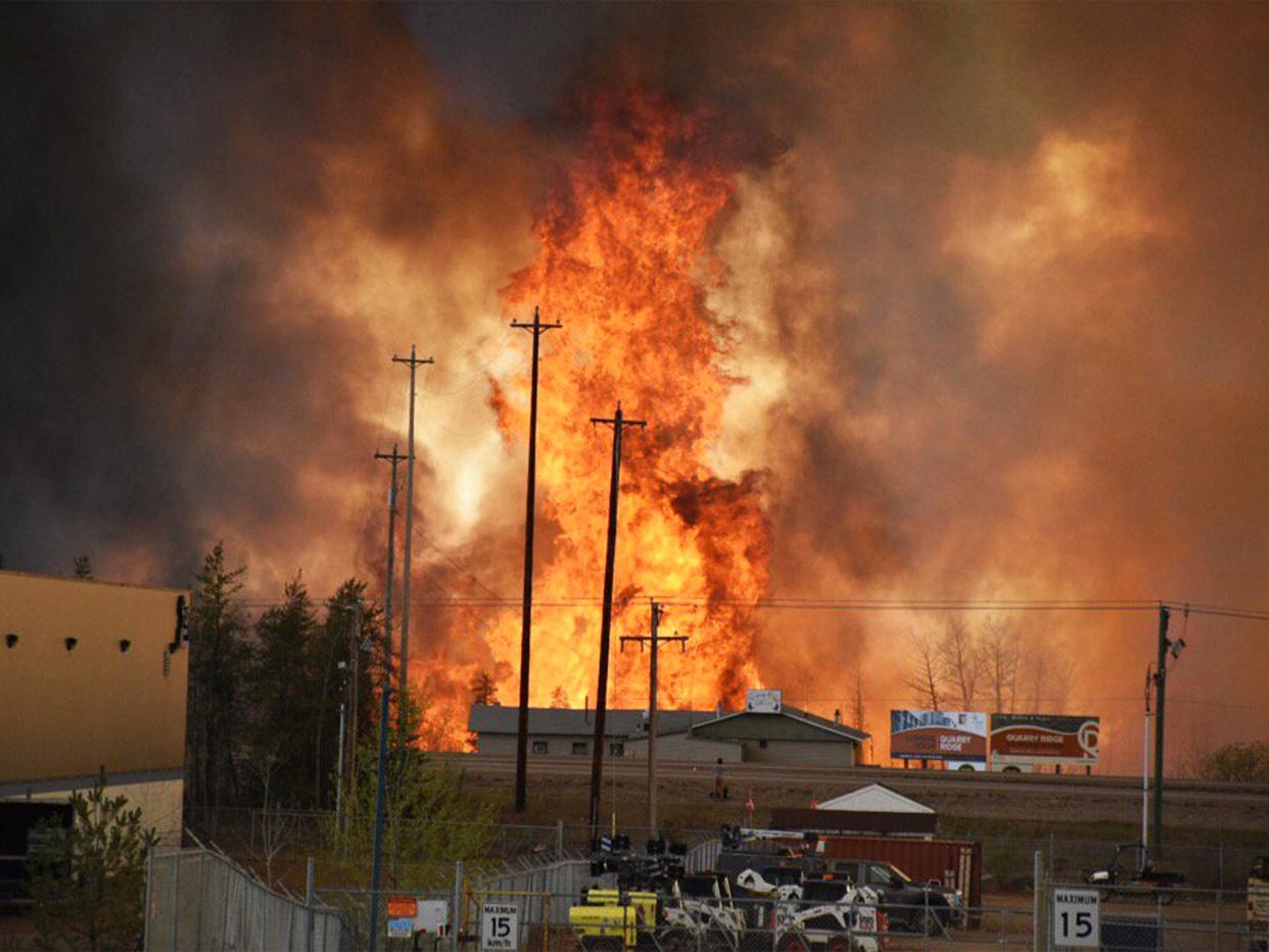 Flames rise in the industrial area of Fort McMurray, Alberta (CBS News)