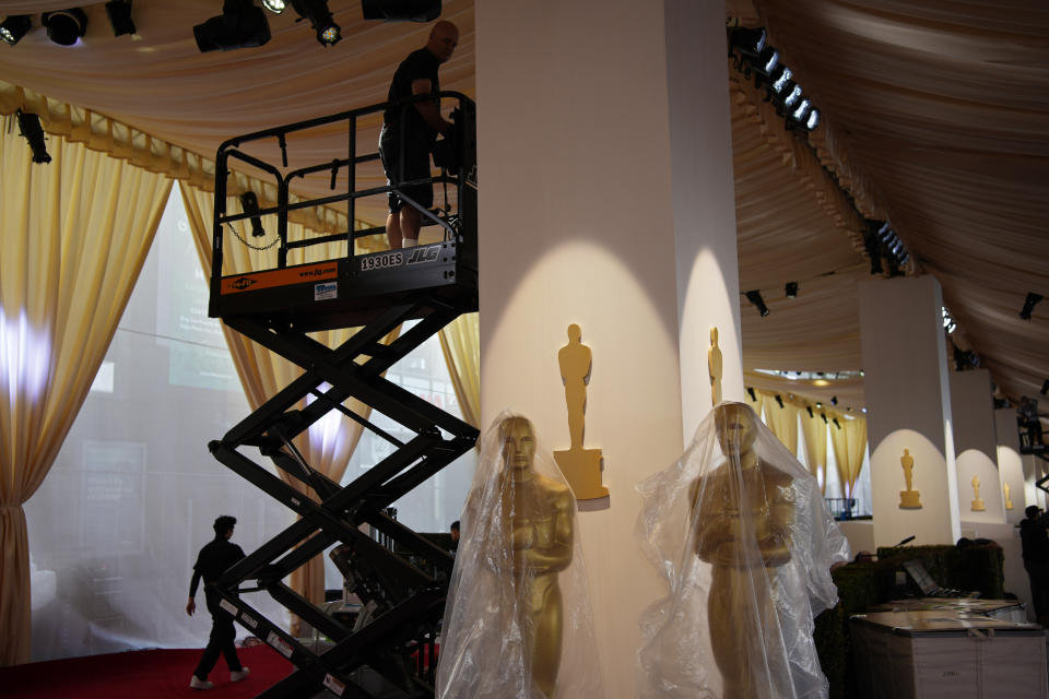 Workers prepare the Oscars red carpet ahead of the 96th Academy Awards Friday, March 8, 2024, in Los Angeles. (AP Photo/John Locher)