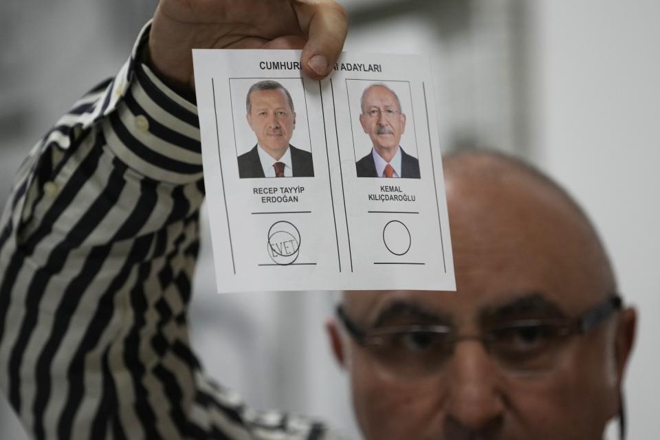 FILE - An election representative shows a ballot with a vote for the Turkish President and leader of the People's Alliance party Recep Tayyip Erdogan, at a polling station in Istanbul, Turkey, Sunday, May 28, 2023.Recep Tayyip Erdogan, 69, takes the oath of office Saturday and starts his third presidential term after scoring another electoral victory last month. Already the longest-serving leader in the republic's history, Erdogan will now be stretching his rule into a third decade - until 2028 – and possibly even longer with the help of a friendly parliament. (AP Photo/Emrah Gurel, File)