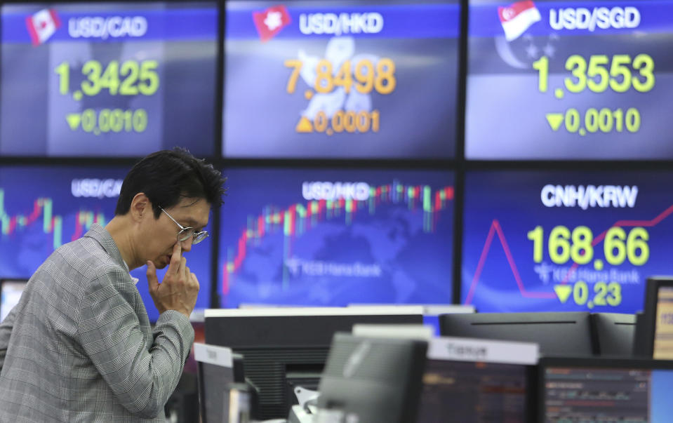 A currency trader watches monitors at the foreign exchange dealing room of the KEB Hana Bank headquarters in Seoul, South Korea, Friday, March 29, 2019. Asian markets were mostly higher on Friday as U.S. and Chinese officials kicked off a fresh round of trade talks in Beijing. (AP Photo/Ahn Young-joon)