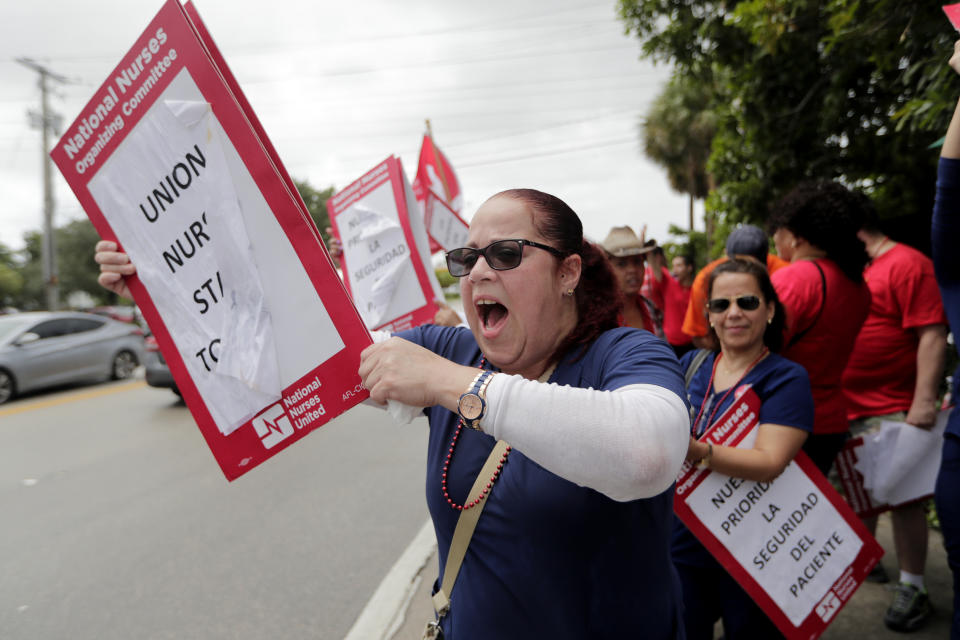 Nurse Cindy Rodriguez shouts during a one-day strike outside of Palmetto General Hospital, Friday, Sept. 20, 2019, in Hialeah, Fla. Registered nurses staged a one-day strike against Tenet Health hospitals in Florida, California and Arizona on Friday, demanding higher wages and better working conditions. (AP Photo/Lynne Sladky)