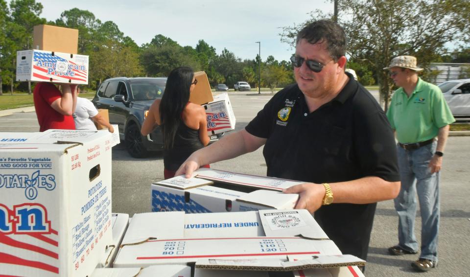 Florida Rep. Randy Fine hands out food at a Farm Share Food Distribution event he sponsored in Palm Bay in November. In addition to the zoo, Fine also pulled requests for more than $6.1 million in funding for public works projects in Palm Bay.