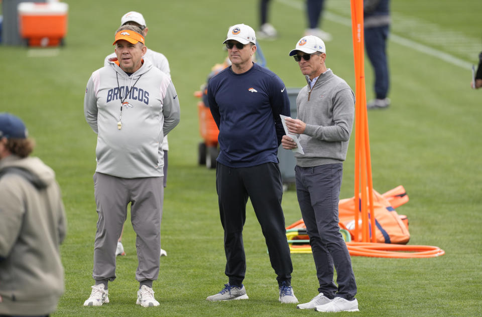 Denver Broncos head coach Sean Payton, left, general manager George Paton, center, and part-owner and chief executive officer Greg Penner look on as players take part in drills during the NFL football team's rookie minicamp, Saturday, May 13, 2023, in Centennial, Colo. (AP Photo/David Zalubowski)