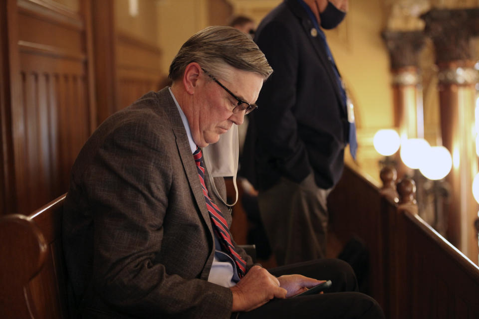 Chuck Weber, a lobbyist for the Kansas Catholic Conference, follows a state Senate debate on a proposed anti-abortion amendment to the state constitution from a Senate gallery, Thursday, Jan. 28, 2021, in Topeka, Kan. The proposed amendment would overturn a Kansas Supreme Court decision protecting abortion rights. (AP Photo/John Hanna)