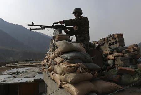 An Afghan National Army (ANA) soldier keeps watch at the Forward Base in Nari district near the army outpost in Kunar province, February 24, 2014. REUTERS/Omar Sobhani