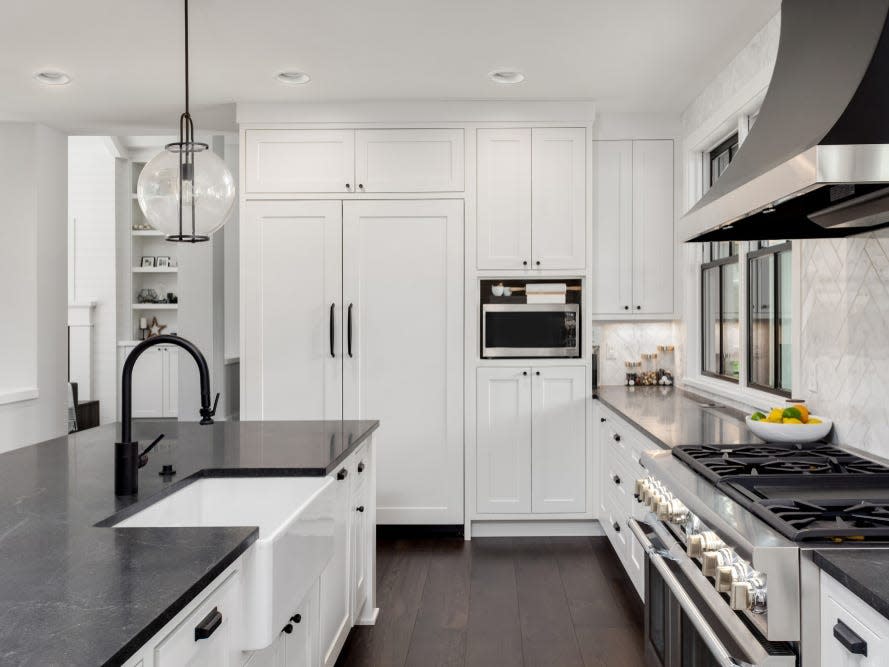 farmhouse kitchen with white cabinets and black accents