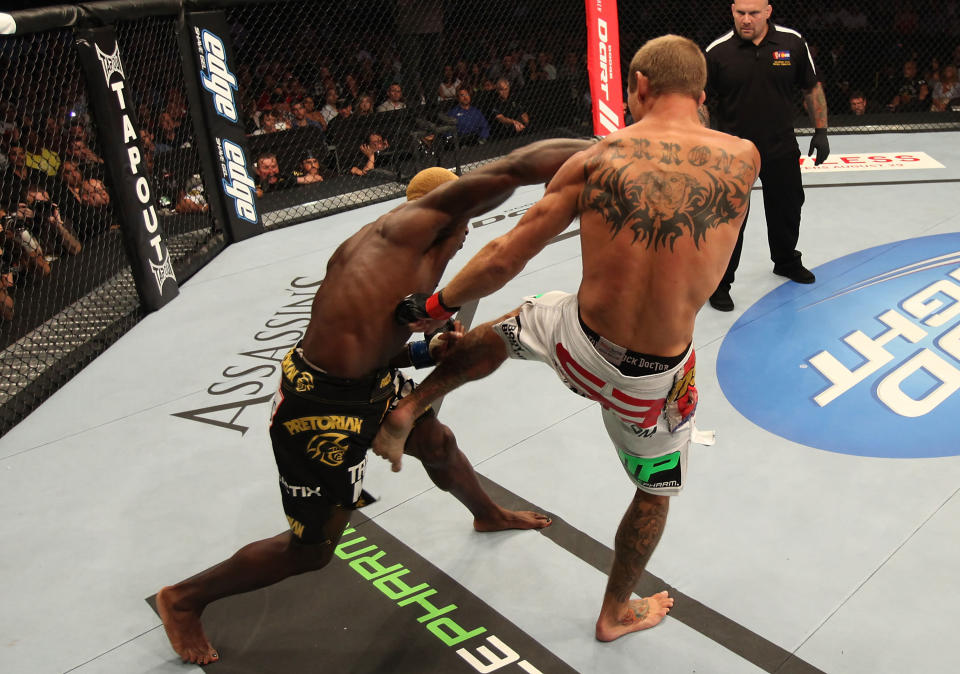 Donald Cerrone throws a kick to the body of Melvin Guillard during their lightweight bout at UFC 150 inside Pepsi Center on August 11, 2012 in Denver, Colorado. (Photo by Nick Laham/Zuffa LLC/Zuffa LLC via Getty Images)