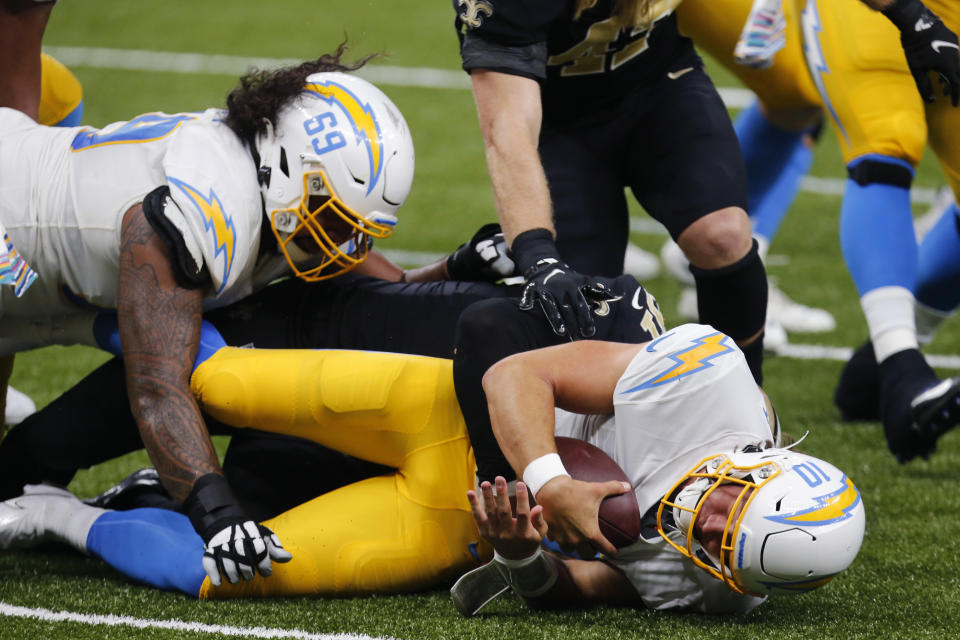 Los Angeles Chargers quarterback Justin Herbert (10) is sacked by New Orleans Saints defensive end Trey Hendrickson (91) in the first half of an NFL football game in New Orleans, Monday, Oct. 12, 2020. (AP Photo/Brett Duke)
