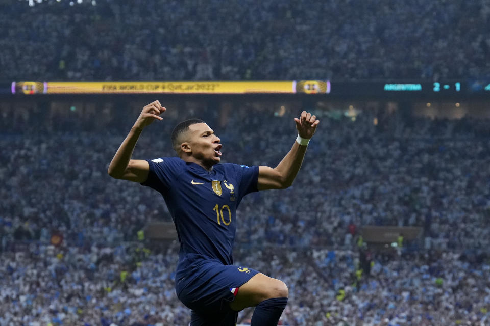 France's Kylian Mbappe celebrates scoring his side's second goal during the World Cup final soccer match between Argentina and France at the Lusail Stadium in Lusail, Qatar, Sunday, Dec. 18, 2022. (AP Photo/Natacha Pisarenko)