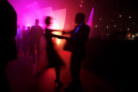 FILE PHOTO: Revellers dance at an office Christmas party in London December 13, 2007. REUTERS/Finbarr O'Reilly