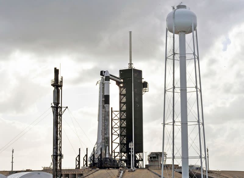 The SpaceX Crew Dragon sits atop a Falcon 9 booster rocket on Pad 39A at Kennedy Space Center before a scheduled in-flight abort test at Cape Canaveral