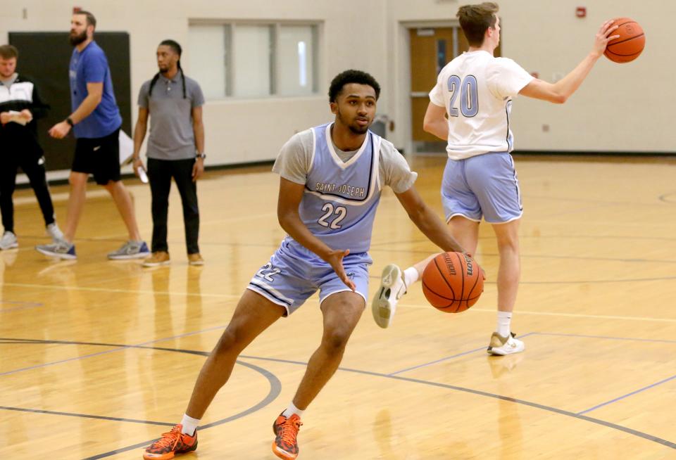 Tyler Brown, junior on the Saint Joseph High School basketball team, practices Thursday, Nov. 16, 2023, in the SJHS auxiliary gym.