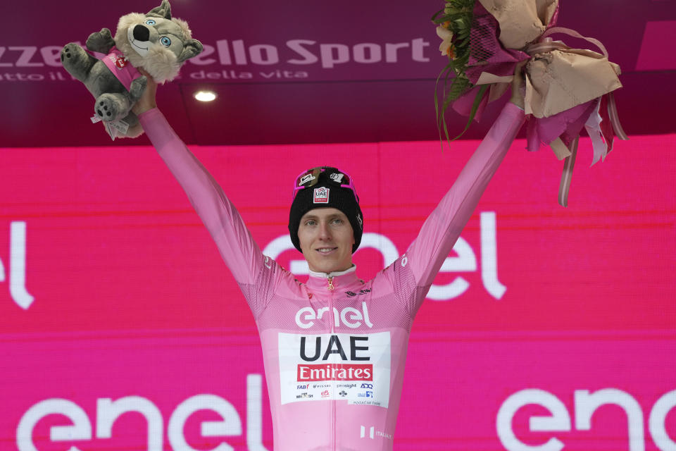 Slovenia's Tadej Pogacar, wearing the pink jersey of the race overall leader, celebrates on podium after completing the 10th stage of the Giro d'Italia, Tour of Italy cycling race from Pompei to Cusano Mutri, Italy, Tuesday, May 14, 2024. (Gian Mattia D'Alberto/LaPresse via AP)