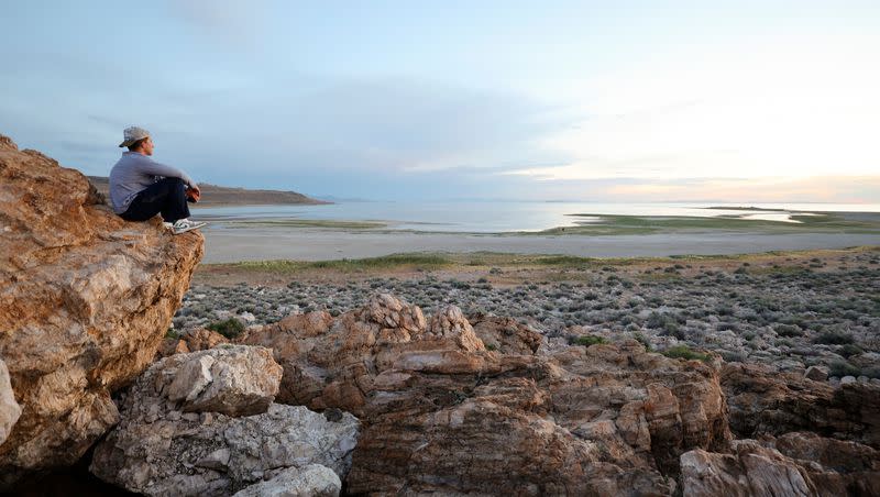 Aleks Kupe watches the sunset over the Great Salt Lake from Ladyfinger Point on Antelope Island on Monday, June 5, 2023.