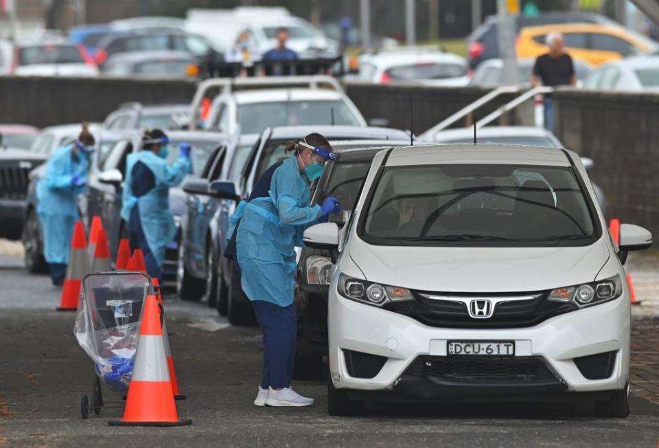 Health workers perform Covid-19 tests at a drive-through testing centre at Bondi Beach in Sydney.