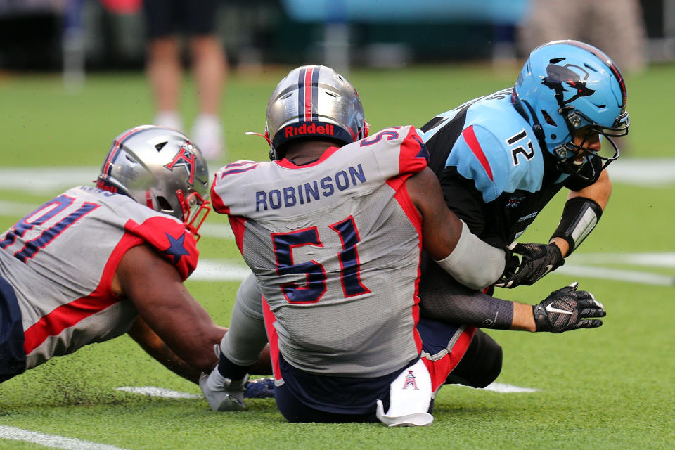 ARLINGTON, TEXAS - MARCH 01: Caushaud Lyons #91 of the Houston Roughnecks and Edmond Robinson #51 of the Houston Roughnecks sack Landry Jones #12 of the Dallas Renegades in the fourth quarter at an XFL football game on March 01, 2020 in Arlington, Texas. (Photo by Richard Rodriguez/Getty Images)