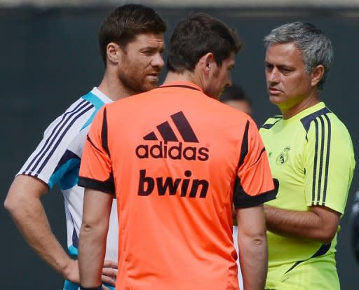 Jose Mourinho (right) speaks with goalkeeper Iker Casillas (centre) and midfielder Xabi Alonso during a training session in Los Angeles, California, on August 1. Last season Mourinho became the first coach to win Spanish, Italian and English titles leading him to suggest a change to the nickname given to him in Britain -- "the special one"