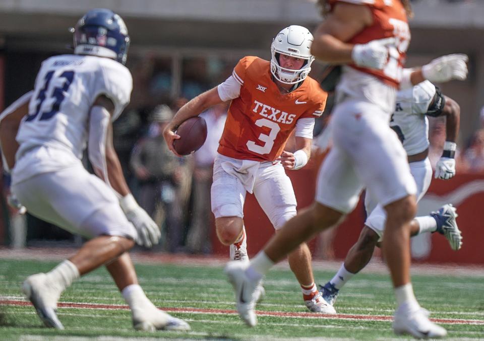 Texas quarterback Quinn Ewers (3) looks for room to run as Rice linebacker Myron Morrison defends during the game, Saturday, Sept. 2, 2023, in Austin, Texas.