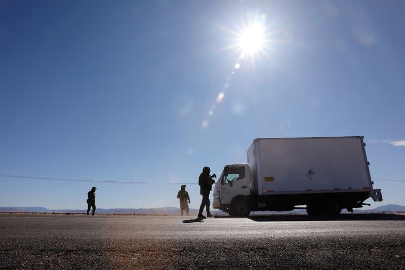 Soldiers check a vehicle at a check point in Janos, Chihuahua