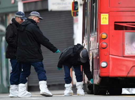 Police search around a London bus on Streatham High Road in south London after a man was shot dead by police following reports he had stabbed two people