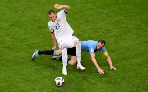 Diego Godin of Uruguay tackles Artem Dzyuba of Russia during the 2018 FIFA World Cup Russia group A match between Uruguay and Russia at Samara Arena on June 25, 2018 in Samara, Russia - Credit:  Getty Images 
