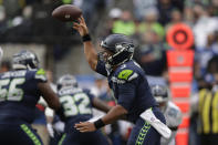 Seattle Seahawks quarterback Russell Wilson passes against the Tennessee Titans during the second half of an NFL football game, Sunday, Sept. 19, 2021, in Seattle. (AP Photo/John Froschauer)