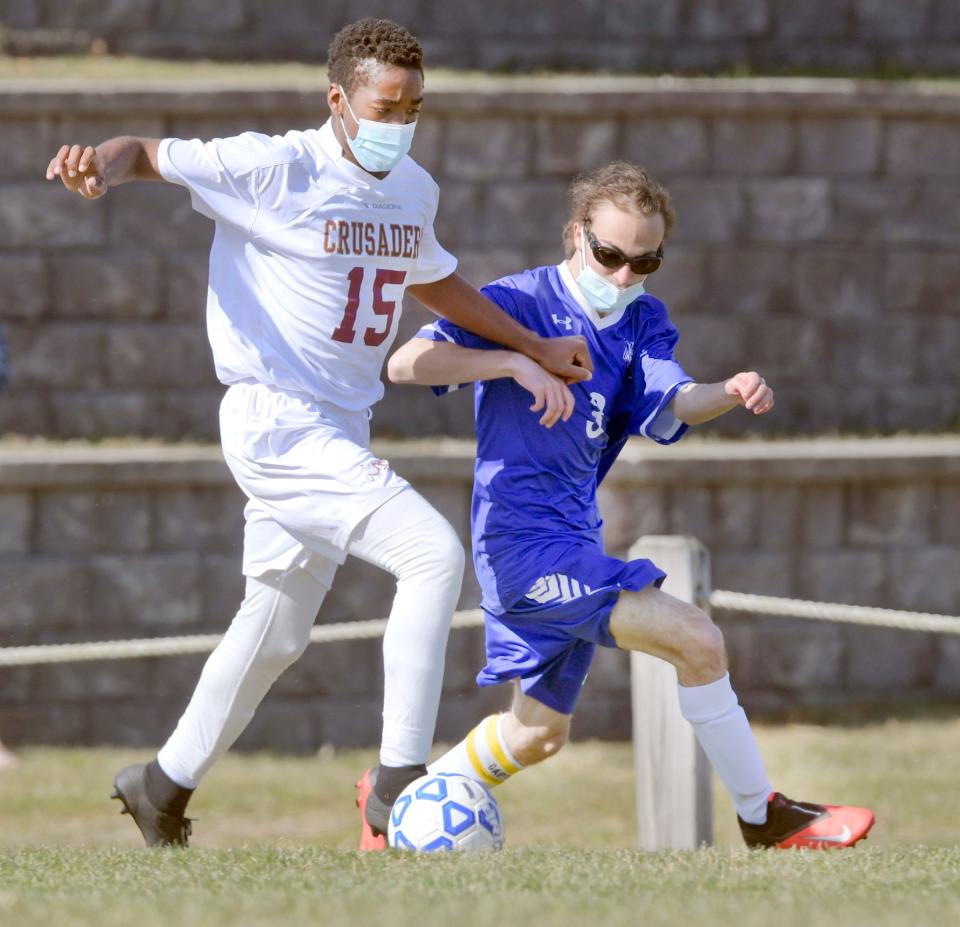 BOURNE  04/06/21  Jemone Rose of Cape Tech and Nathan Baronas of Upper Cape  struggle for position on the ball.Ron Schloerb/Cape Cod Times .