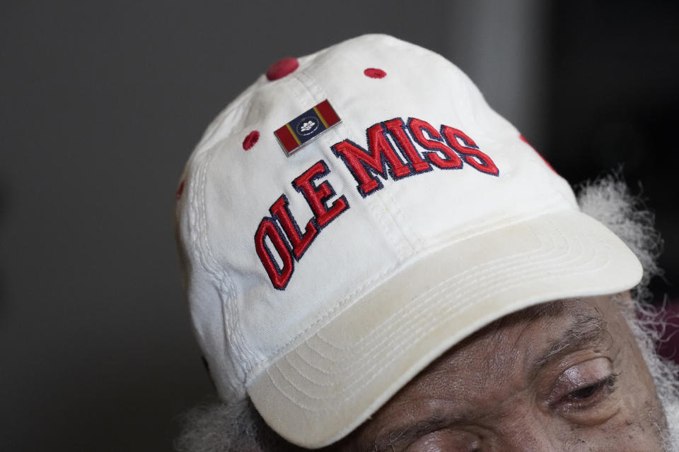 James Meredith, who integrated the University of Mississippi as its first Black student in 1962, wears a hat with a Mississippi state flag pin and one of the school's logos at his home in Jackson, Miss., Thursday, Oct. 28, 2021. A person close to Meredith is selling “New Miss” merchandise and trying to trademark a logo with cursive script that is nearly identical to the university's Ole Miss logo. The university is fighting the trademark effort. (AP Photo/Rogelio V. Solis)