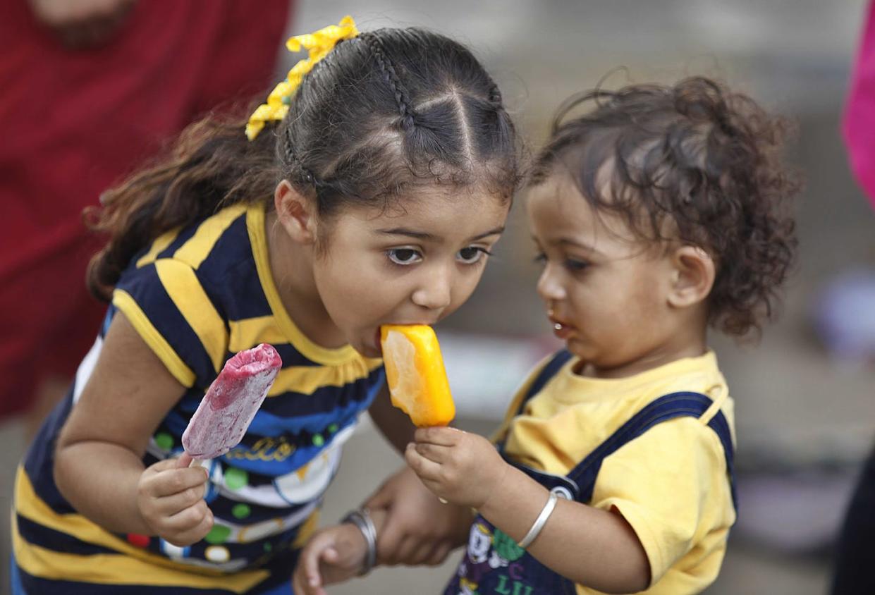 <span class="caption">Cold and sweet in the heat.</span> <span class="attribution"><a class="link " href="https://www.gettyimages.com/detail/news-photo/children-enjoy-icecream-during-the-hot-afternoon-on-june-7-news-photo/450223408?adppopup=true" rel="nofollow noopener" target="_blank" data-ylk="slk:Raj K Raj/Hindustan Times via Getty Images;elm:context_link;itc:0;sec:content-canvas">Raj K Raj/Hindustan Times via Getty Images</a></span>